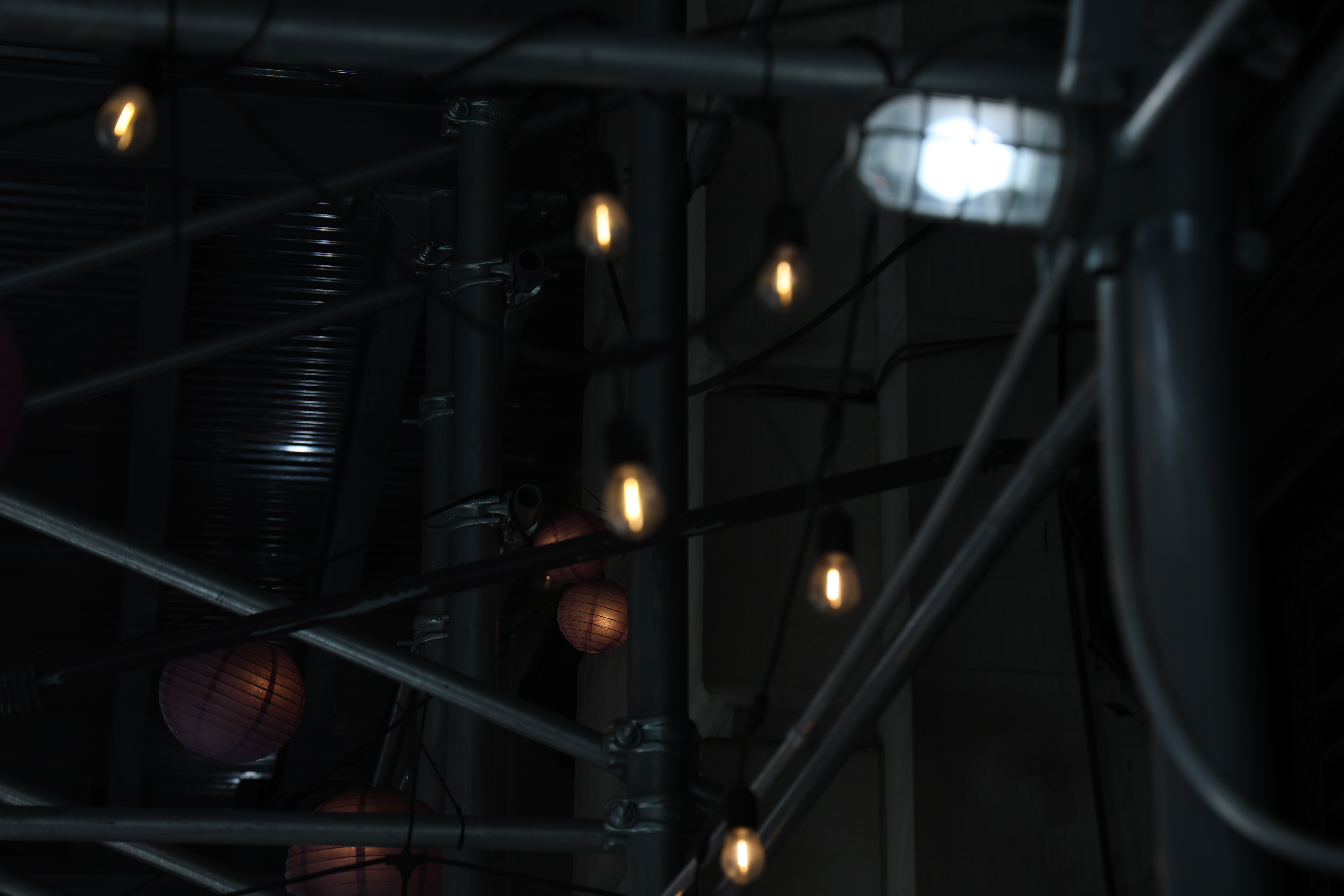 Dark scaffolding and small lights photographed in New York